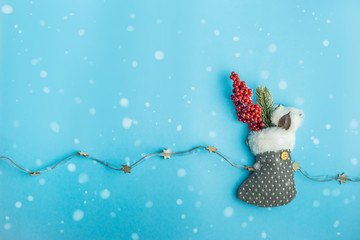  Beautiful Christmas sock with a Christmas tree and holly berries hangs on a blue wall. Christmas...