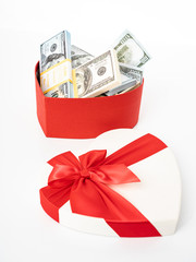 Dollars in a  gift box on a white background.  Valentine's Day. Birthday. Saving money.