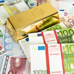 Gold bars and Euro banknotes. Gold bullion and money