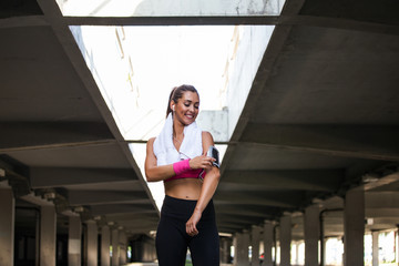 young beautiful woman jogging, fitness outfit, listening to music on headphones, smartphone, sea sunrise, skinny perfect slim body, healthy living lifestyle, summer, smiling, happy