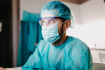 male surgeon in uniform is studying in a medical office. Young specialist.