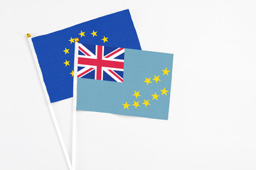 Tuvalu and European Union stick flags on white background. High quality fabric, miniature national flag. Peaceful global concept.White floor for copy space.