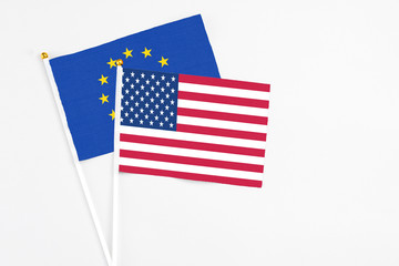 United States and European Union stick flags on white background. High quality fabric, miniature national flag. Peaceful global concept.White floor for copy space.