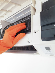 Modern airconditioner unit service cleaning the filter to prevent respiratory disease.