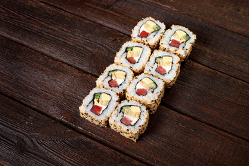 Sushi rolls on a wooden table