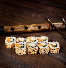 Sushi rolls on a wooden table