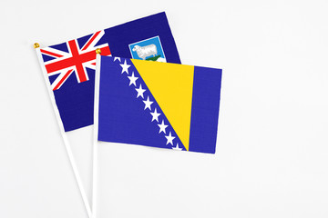 Bosnia Herzegovina and Falkland Islands stick flags on white background. High quality fabric,...
