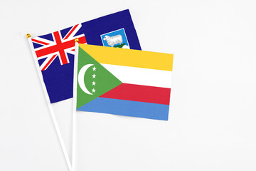 Comoros and Falkland Islands stick flags on white background. High quality fabric, miniature...