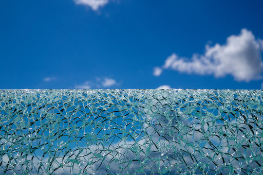 Cracked Glass Surface Against Blue Sky