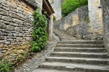 Stone stairs along the ancient buildings of the French small town in Perigord