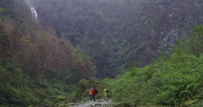 Back view of Three middle age asian woman female friends hiking in the mountain people lifestyle enjoy the nature 4k clip friends talking enjoy nature outdoor