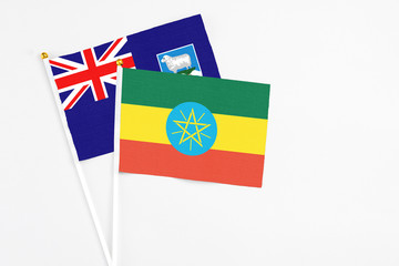 Ethiopia and Falkland Islands stick flags on white background. High quality fabric, miniature national flag. Peaceful global concept.White floor for copy space.