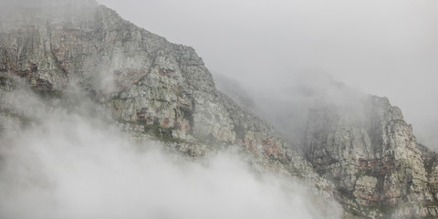 Dramatic mountainscape with cloud cover on an overcast day.