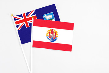 French Polynesia and Falkland Islands stick flags on white background. High quality fabric,...