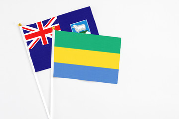 Gabon and Falkland Islands stick flags on white background. High quality fabric, miniature national...