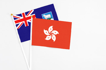 Hong Kong and Falkland Islands stick flags on white background. High quality fabric, miniature...