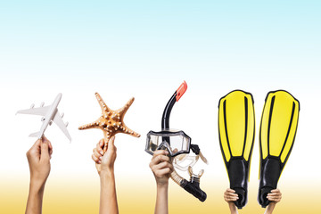 Concept on the subject of snorkeling and diving. Hands holding various leisure accessories with...