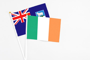 Ireland and Falkland Islands stick flags on white background. High quality fabric, miniature national flag. Peaceful global concept.White floor for copy space.