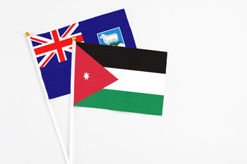 Jordan and Falkland Islands stick flags on white background. High quality fabric, miniature national flag. Peaceful global concept.White floor for copy space.