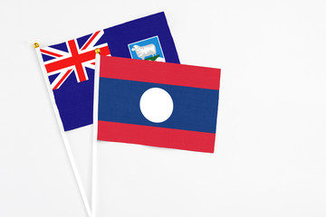 Laos and Falkland Islands stick flags on white background. High quality fabric, miniature national flag. Peaceful global concept.White floor for copy space.