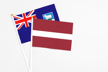 Latvia and Falkland Islands stick flags on white background. High quality fabric, miniature...