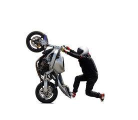 A motorcyclist in a white helmet performs a stunt on a sports motorcycle