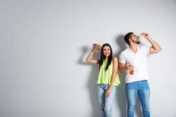 Obraz premium Happy couple with pizza and beer on white background, copy space text