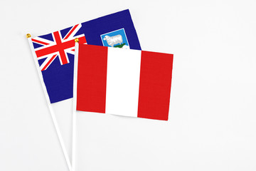 Peru and Falkland Islands stick flags on white background. High quality fabric, miniature national flag. Peaceful global concept.White floor for copy space.