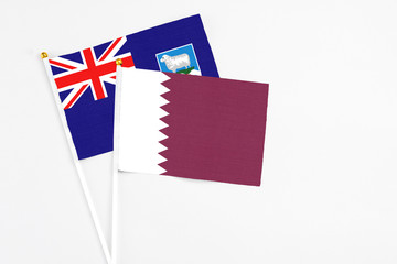 Qatar and Falkland Islands stick flags on white background. High quality fabric, miniature national flag. Peaceful global concept.White floor for copy space.