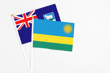 Rwanda and Falkland Islands stick flags on white background. High quality fabric, miniature national flag. Peaceful global concept.White floor for copy space.