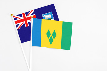 Saint Vincent And The Grenadines and Falkland Islands stick flags on white background. High quality fabric, miniature national flag. Peaceful global concept.White floor for copy space.