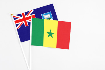 Senegal and Falkland Islands stick flags on white background. High quality fabric, miniature national flag. Peaceful global concept.White floor for copy space.