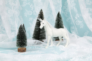 snow unicorn on a lace background © Loulou02