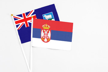 Serbia and Falkland Islands stick flags on white background. High quality fabric, miniature...