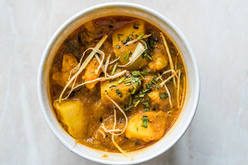 Take Away Indian Food Spicy Masaledar Aloo Gobi with Soybean Sprouts and Beans Tawa Sabzi in Plastic Cup Box Package / Container.