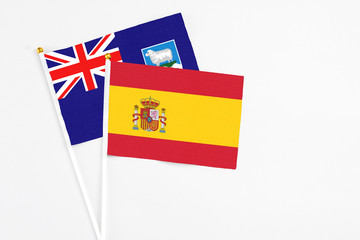 Spain and Falkland Islands stick flags on white background. High quality fabric, miniature national flag. Peaceful global concept.White floor for copy space.