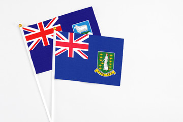 Fototapeta premium British Virgin Islands and Falkland Islands stick flags on white background. High quality fabric, miniature national flag. Peaceful global concept.White floor for copy space.