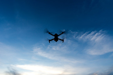 Naklejka na ściany i meble Flying drone and cloud sky