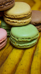 Obraz na płótnie Canvas Colored macarons isolated on wooden dish, typical French dish