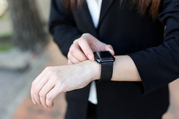  Beautiful Young businesswoman   looking at her smart watch