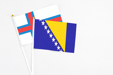 Bosnia Herzegovina and Faroe Islands stick flags on white background. High quality fabric,...