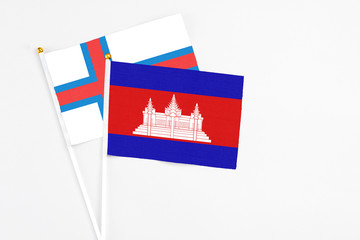 Cambodia and Faroe Islands stick flags on white background. High quality fabric, miniature national flag. Peaceful global concept.White floor for copy space.