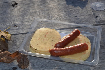 sausages and cheese on a wooden table