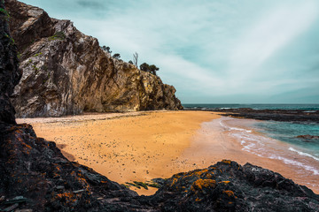 Deserted and secluded beach with cliffs