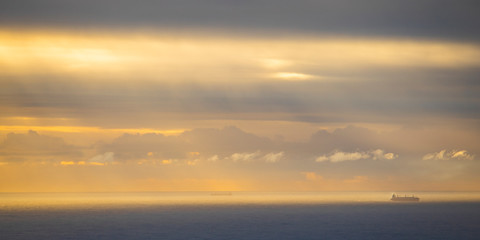 Fishing ships on a golden blue ocean sunset or sunrise in Cape Town.