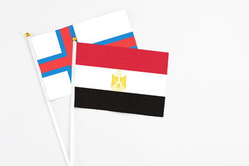 Egypt and Faroe Islands stick flags on white background. High quality fabric, miniature national flag. Peaceful global concept.White floor for copy space.
