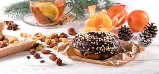 donut with tea on a white wooden background