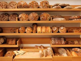 Fotobehang Modern bakery with different kinds of bread, cakes and buns © Oleg Samoylov