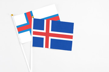 Iceland and Faroe Islands stick flags on white background. High quality fabric, miniature national flag. Peaceful global concept.White floor for copy space.