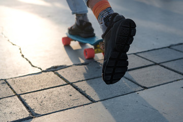 Fragment of a longboard and legs close-up.